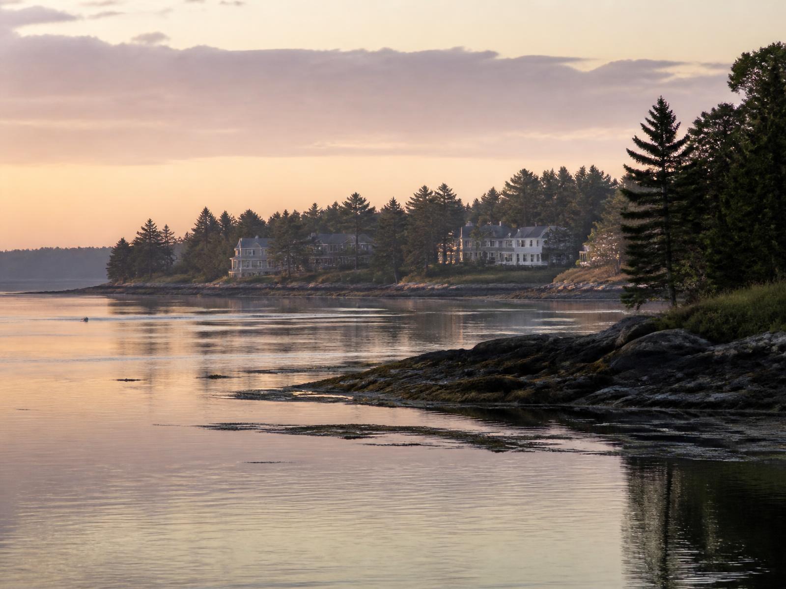 Dawn across the tidal river dividing New Hampshire from the pine-lined Maine shore.